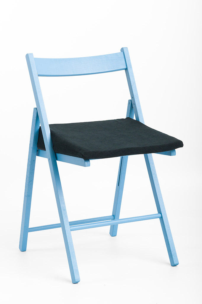 Actyv seat wedge cushion placed on a blue folding chair