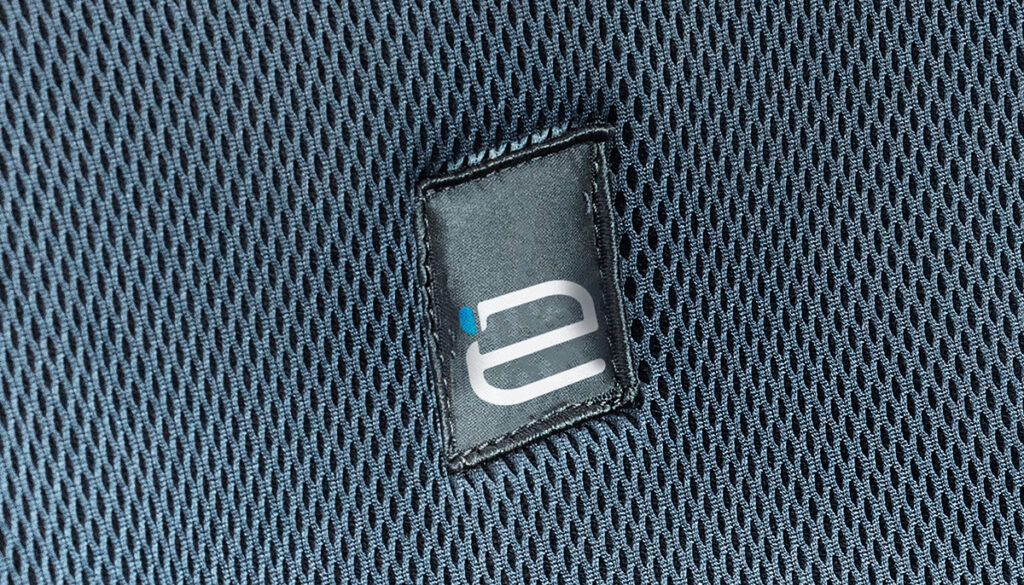 Close-up of Ergochair branded label stitched into the fabric upholstery of an ergonomic chair