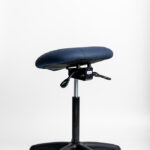 Ergochair Zenki Sit-Stand stool in navy upholstery, side view showing adjustment controls